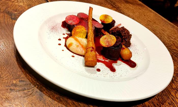 Venison strip loin & ragu from the venison center, piccolo parsnip, beetroot fondant, game jus